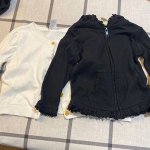 Black- zip up jacket with hood. White cardigan.